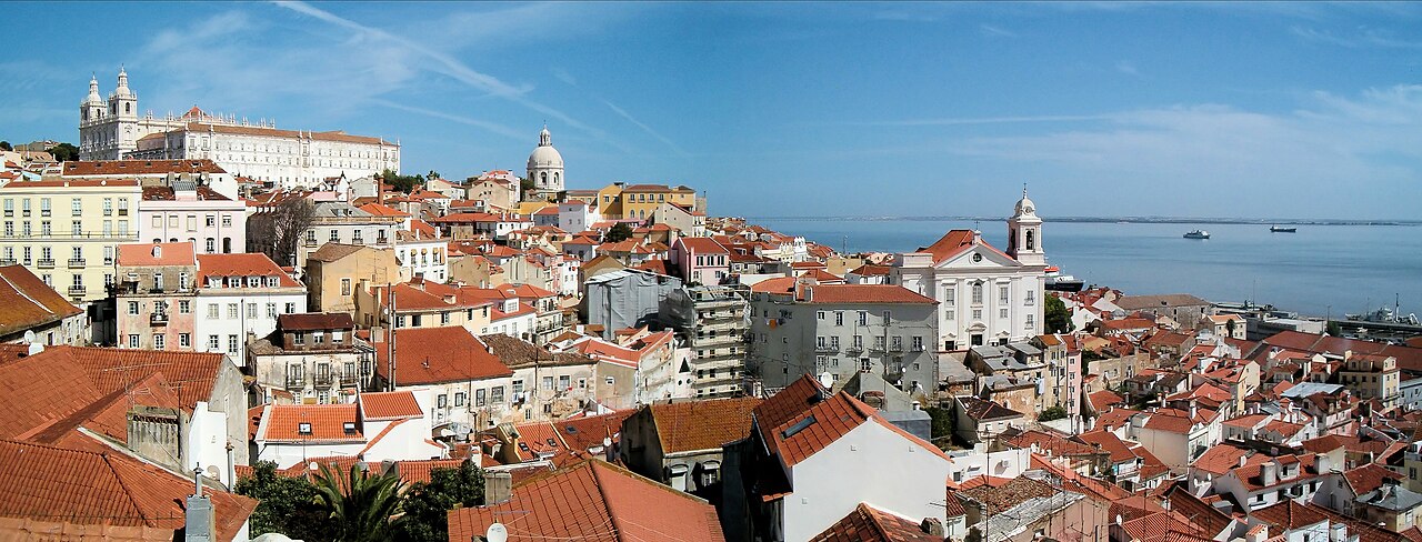 Terracotta rooftops of Lisbon's Alfama district, the dome of Santa Engracia, and the Tagus River